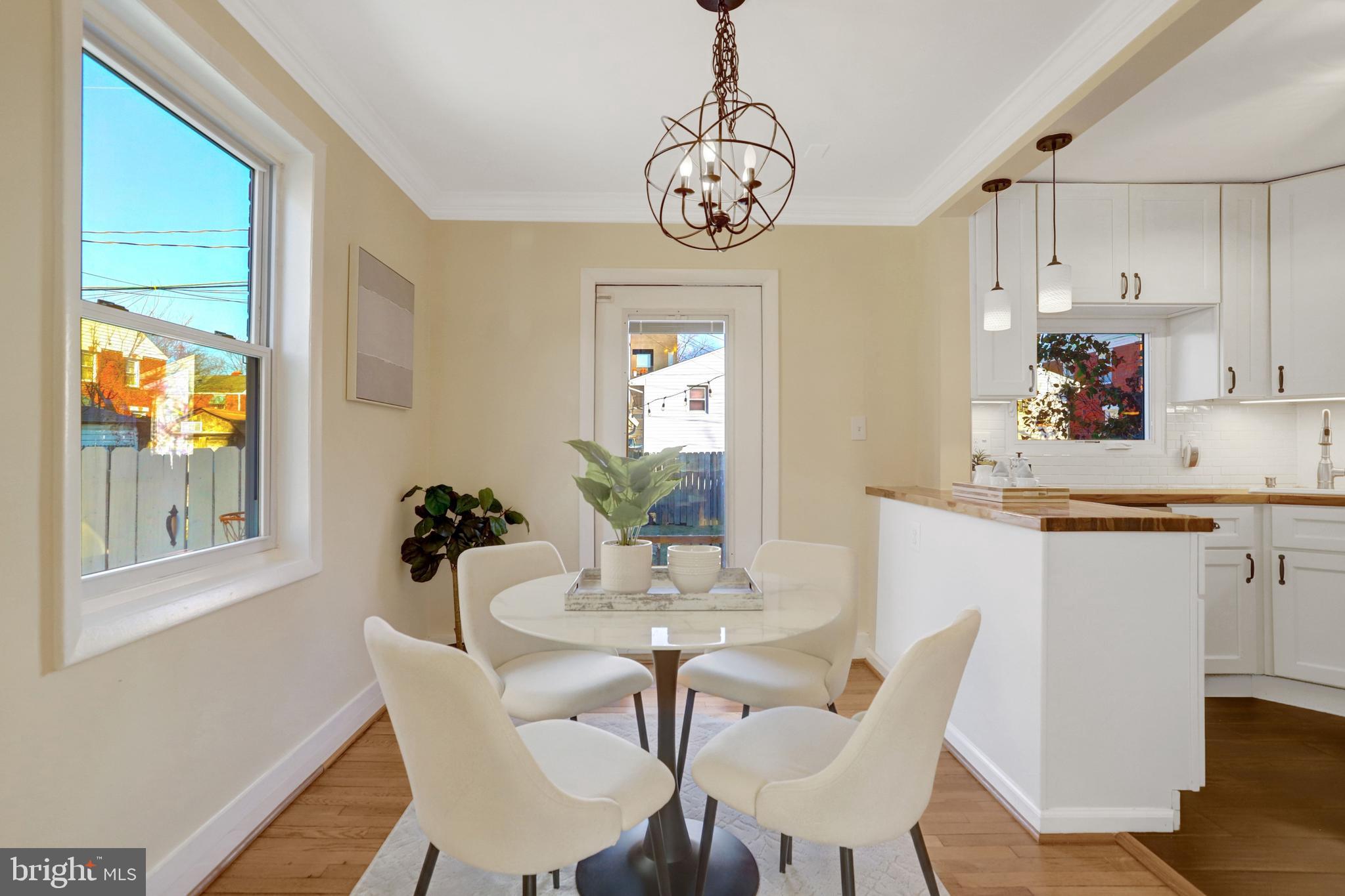 2137 South Pollard Street Arlington, VA 22204 - Photo 11 of 57 a view of a dining room with furniture wooden floor and a chandelier