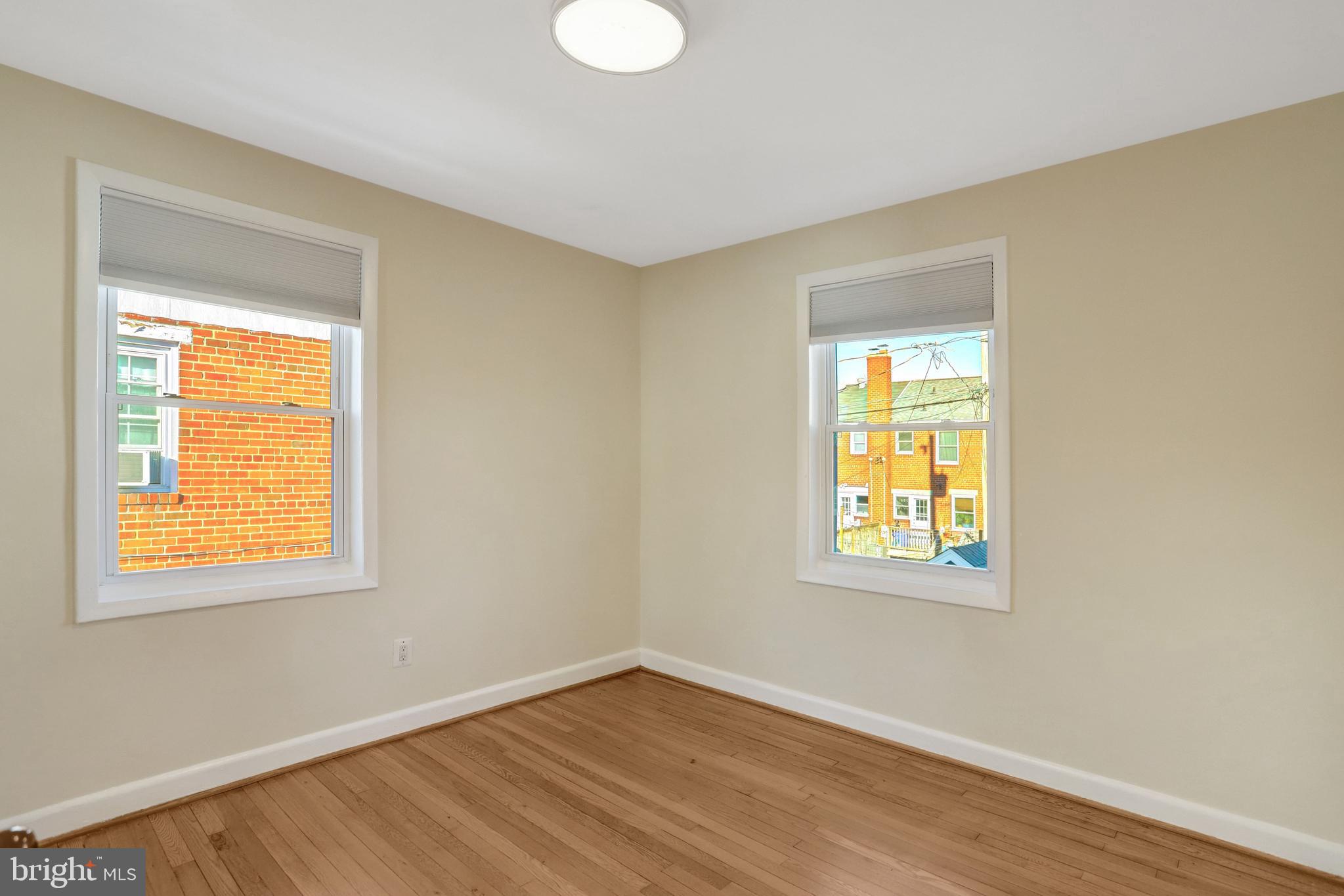 2137 South Pollard Street Arlington, VA 22204 - Photo 27 of 57 a view of an empty room with wooden floor and a window