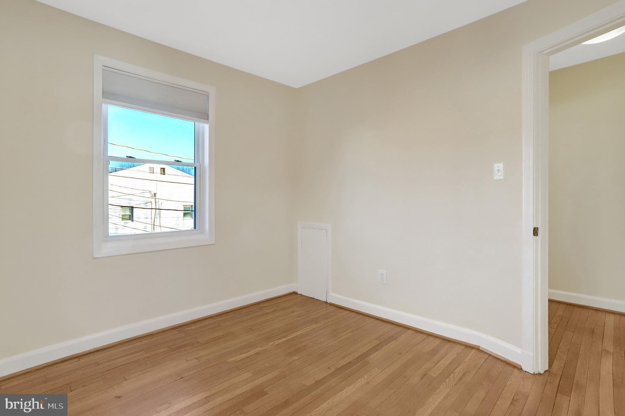 2137 South Pollard Street Arlington, VA 22204 - Photo 28 of 57 an empty room with wooden floor and windows