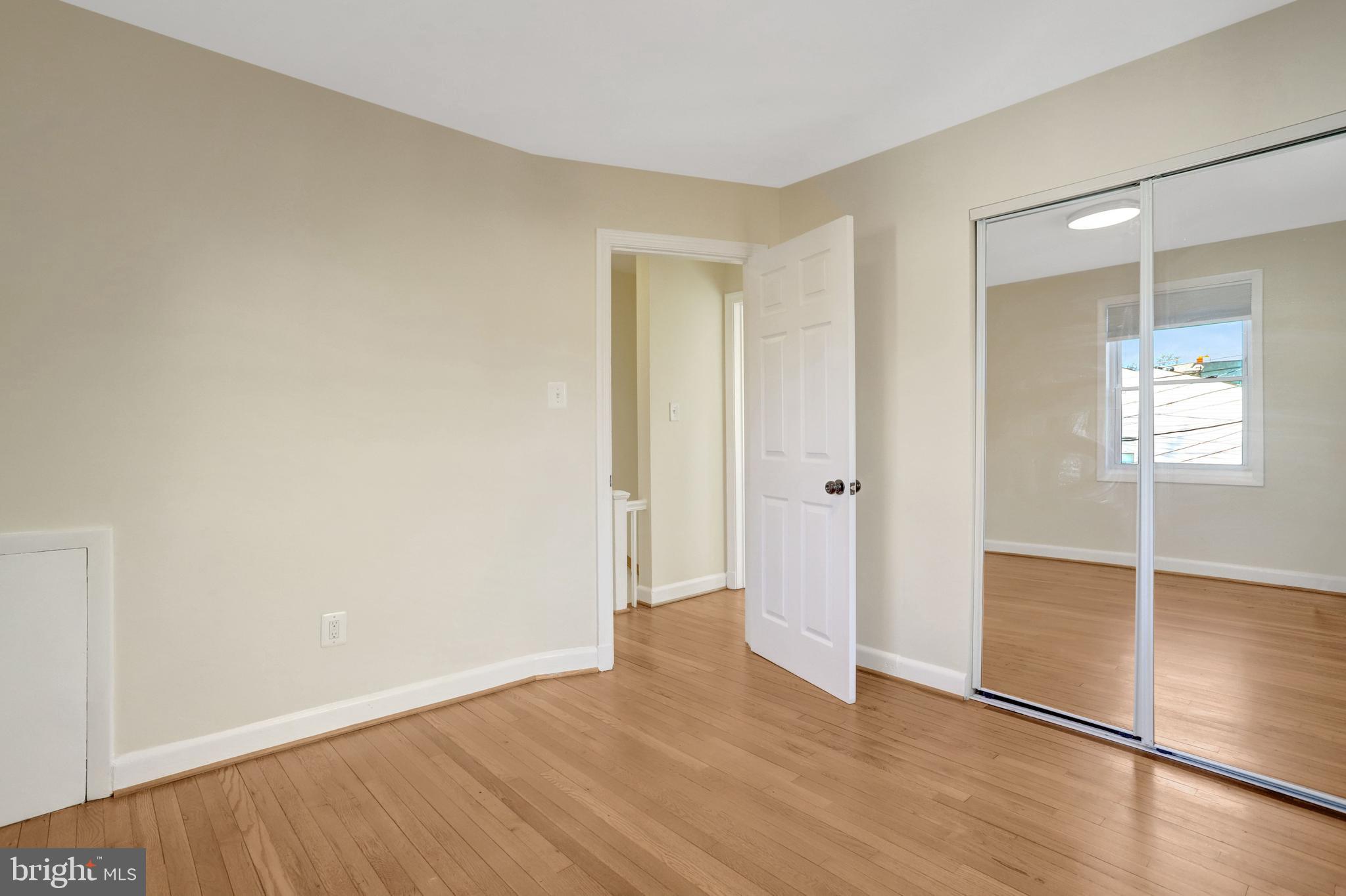 2137 South Pollard Street Arlington, VA 22204 - Photo 29 of 57 an empty room with wooden floor and mirror