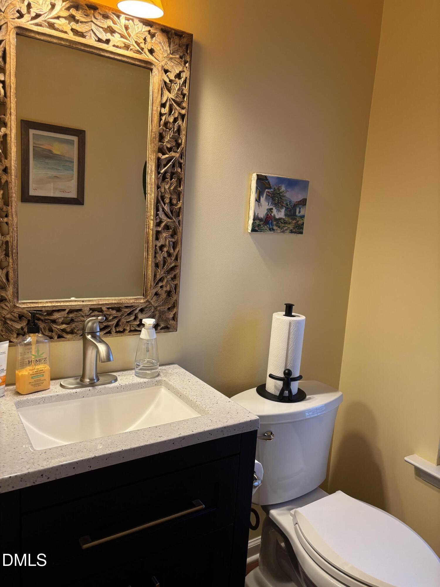 2136 Persimmon Ridge Drive Raleigh, NC 27604 - Photo 13 of 18 a bathroom with a sink mirror vanity and toilet