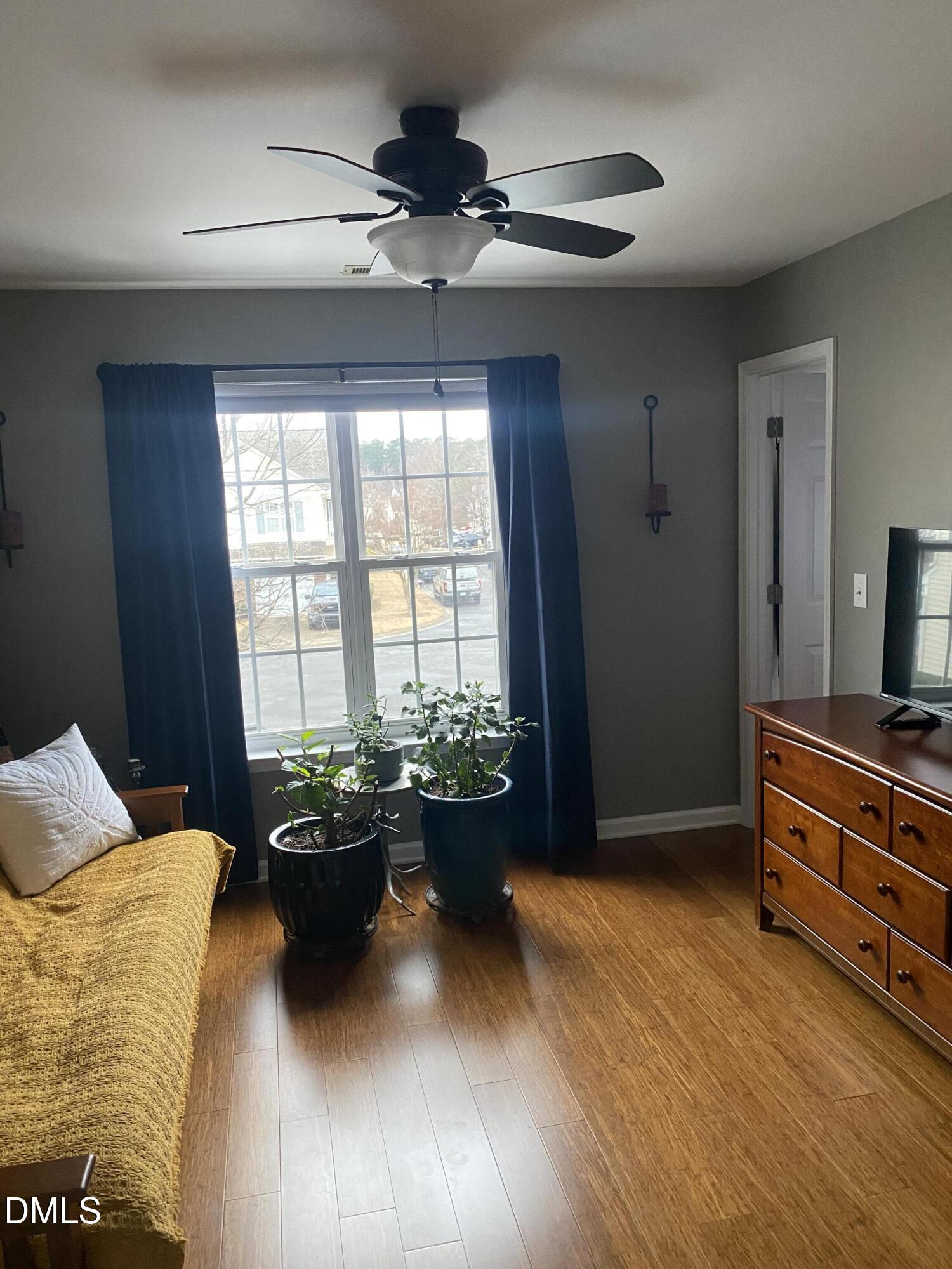 2136 Persimmon Ridge Drive Raleigh, NC 27604 - Photo 7 of 18 a bedroom with a bed and a chandelier