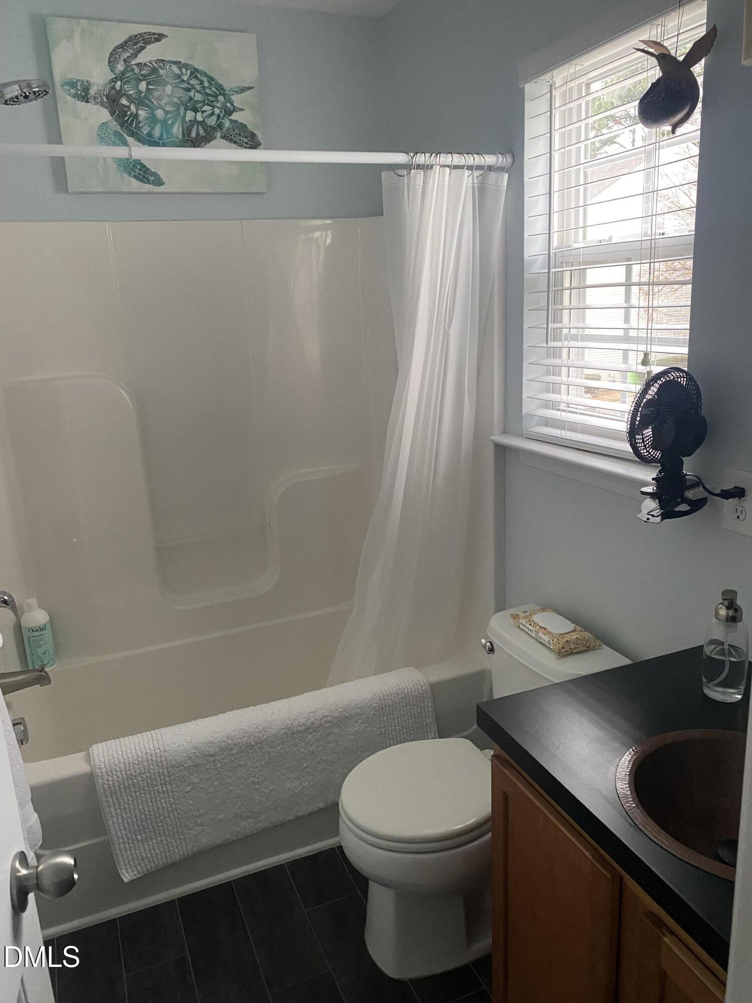 2136 Persimmon Ridge Drive Raleigh, NC 27604 - Photo 9 of 18 a bathroom with a sink a toilet and tub