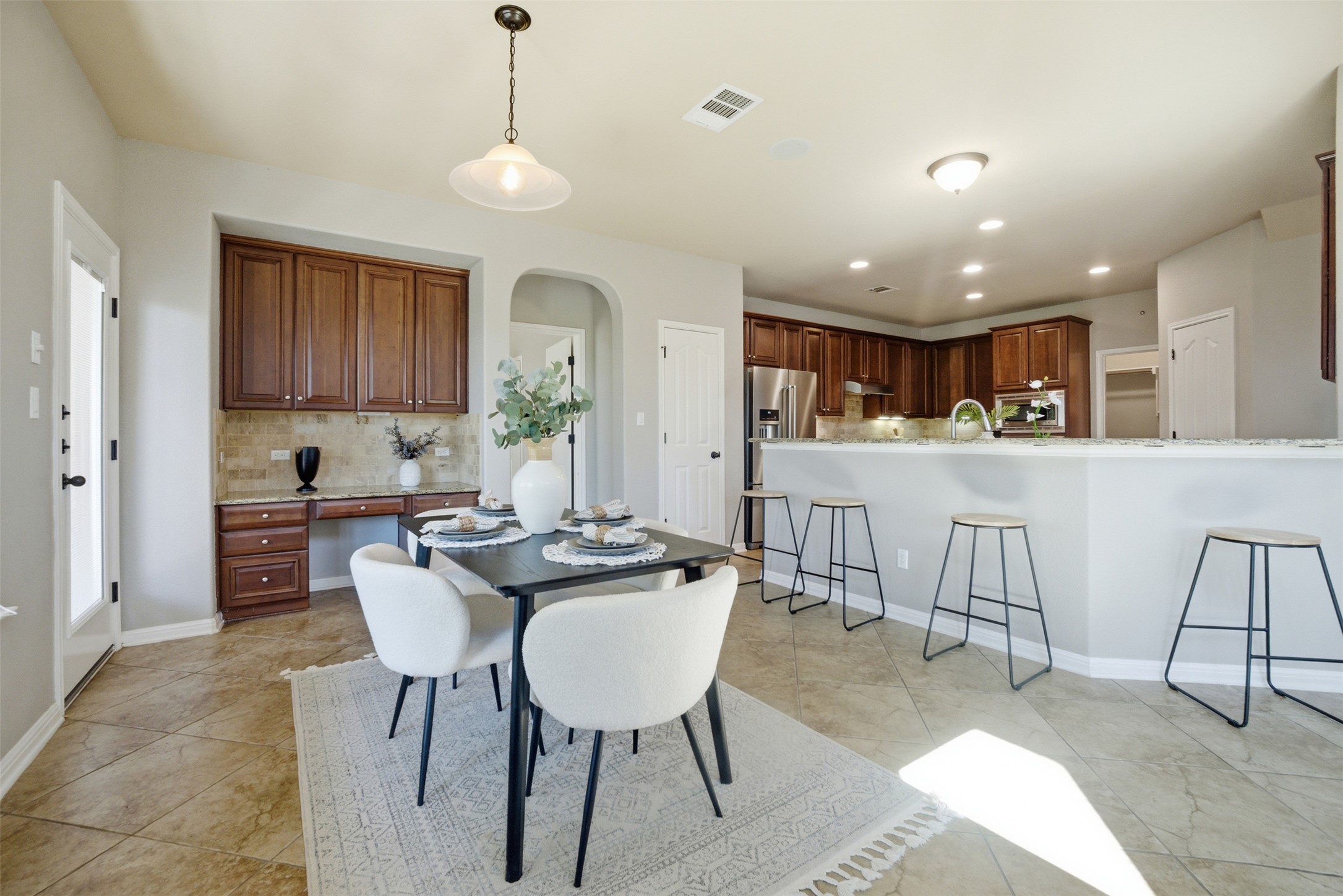 16100 Spillman Ranch Loop Austin, TX 78738 - Photo 15 of 39 a view of kitchen with kitchen island dining table and chairs