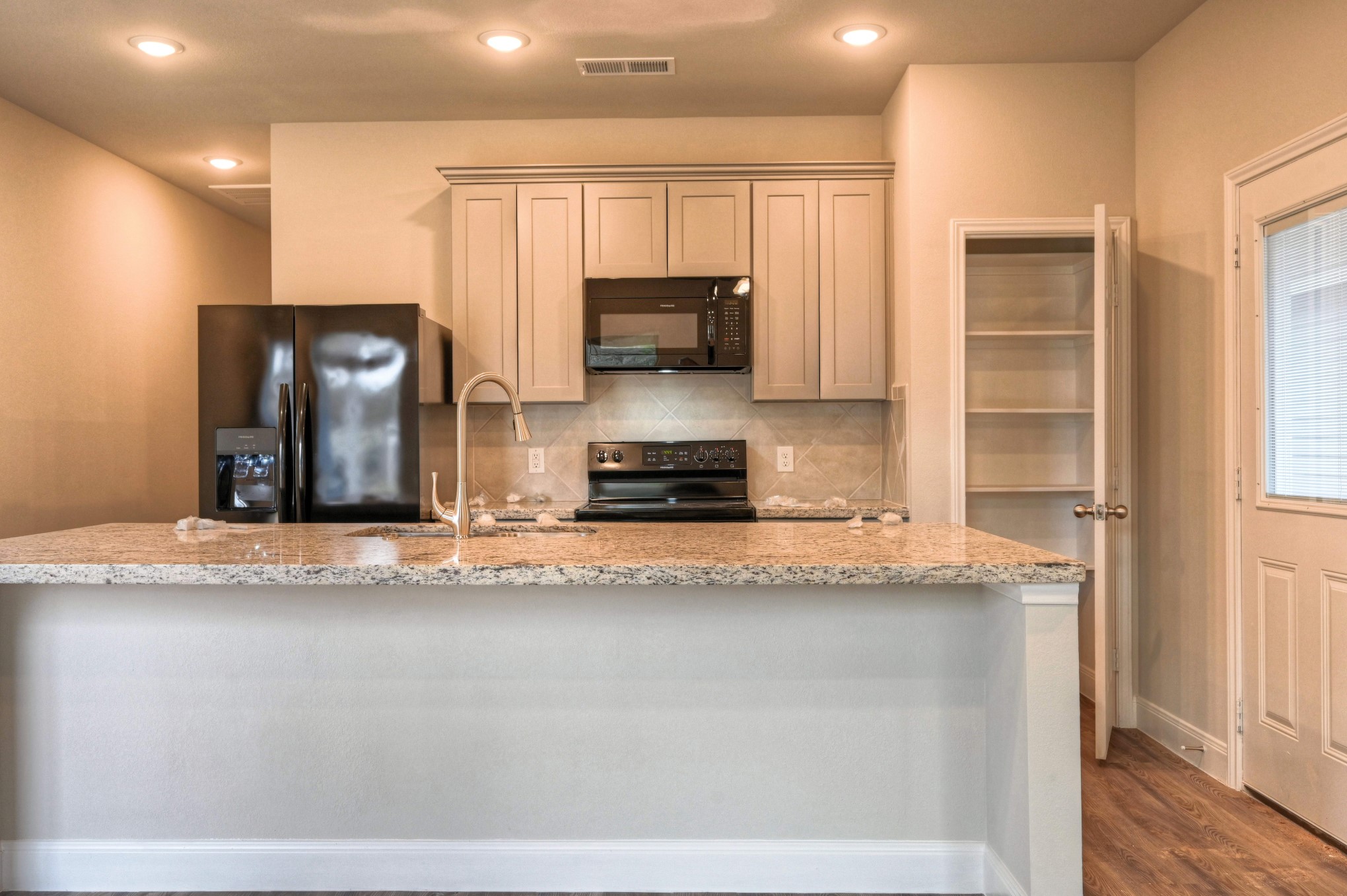9173 Inwood Willis, TX 77318 - Photo 7 of 31 a kitchen with granite countertop a stove and a refrigerator