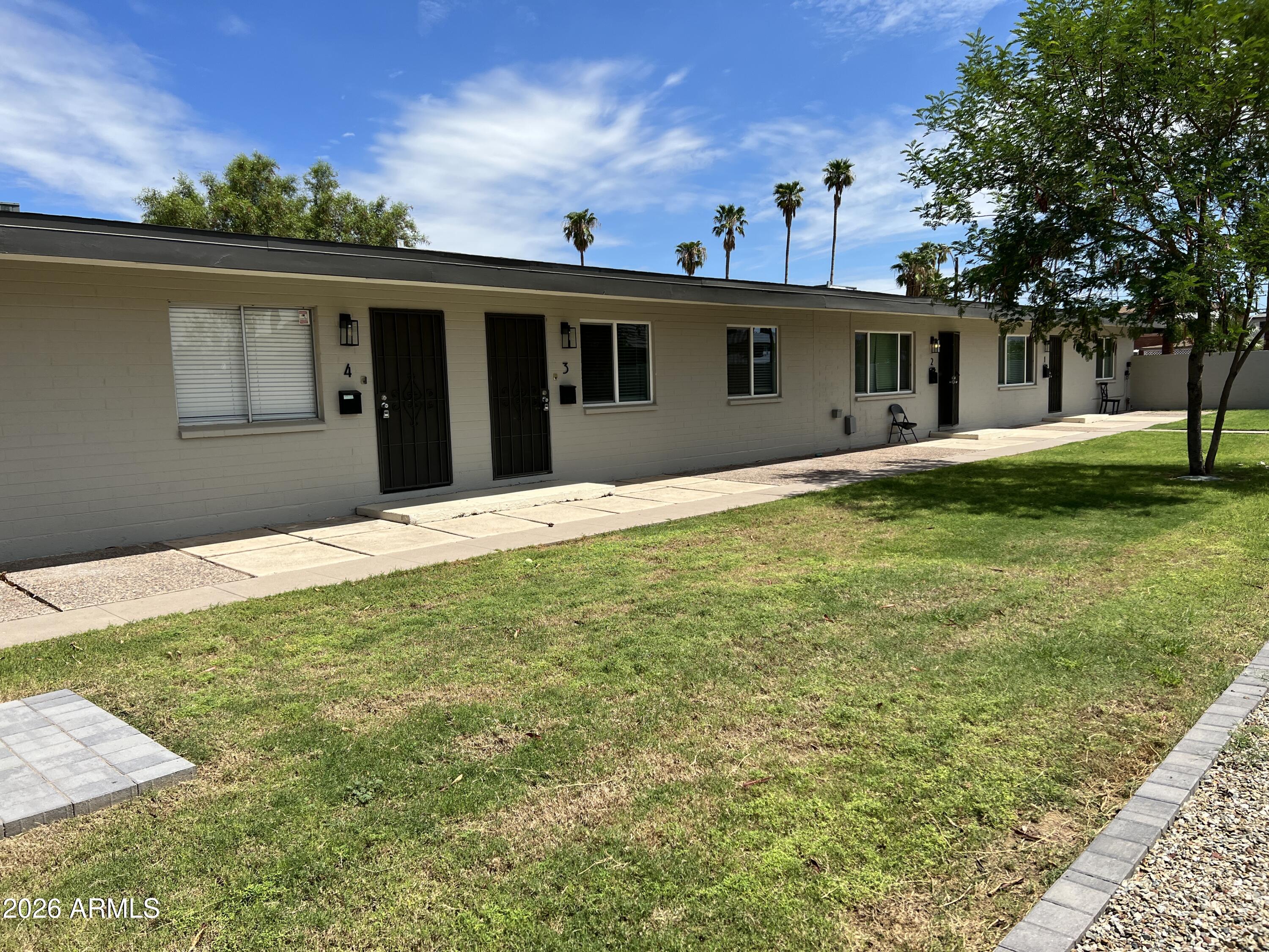 3630 North 15th Avenue Phoenix, AZ 85015 - Photo 1 of 12 a front view of house with yard and trees in the background