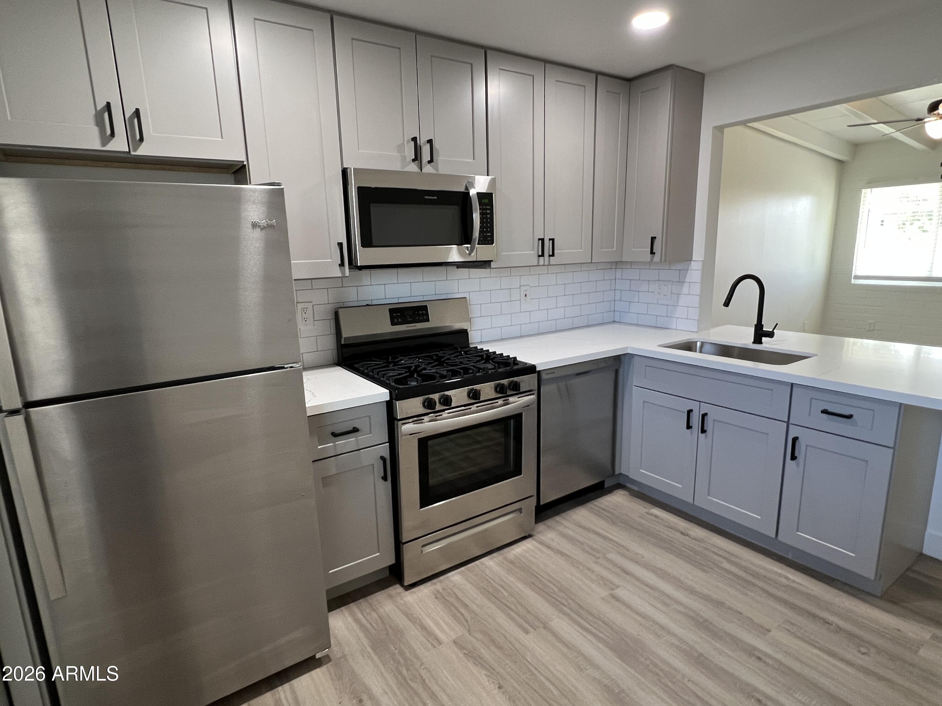 3630 North 15th Avenue Phoenix, AZ 85015 - Photo 3 of 12 a kitchen with a sink appliances and cabinets