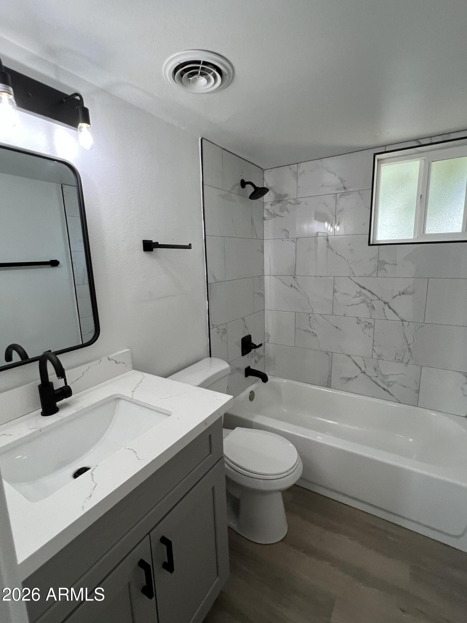 3630 North 15th Avenue Phoenix, AZ 85015 - Photo 6 of 12 a bathroom with a sink a toilet and shower