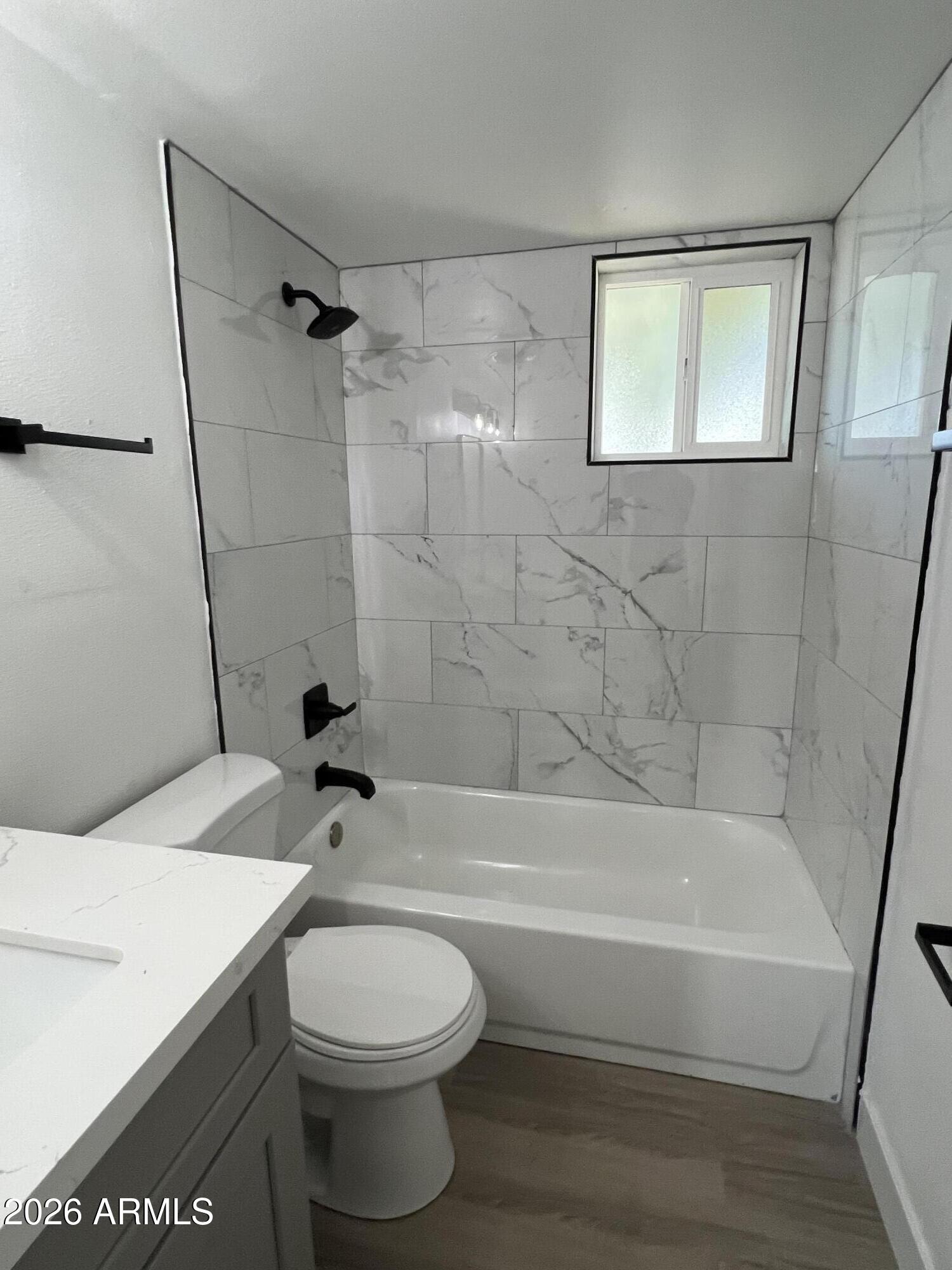 3630 North 15th Avenue Phoenix, AZ 85015 - Photo 7 of 12 a bathroom with a sink a toilet and a bathtub