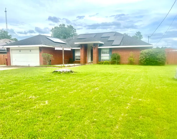 a view of a house with a yard and a garage