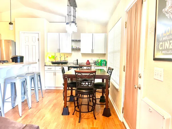 a view of a dining room with furniture and a window