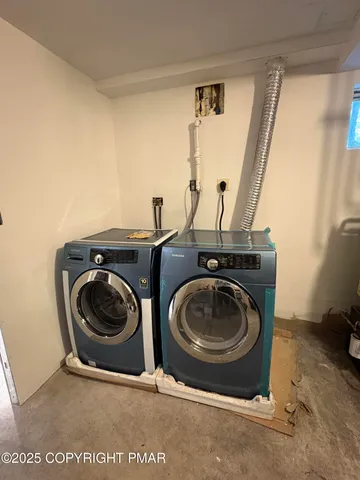 a utility room with sink dryer and washer