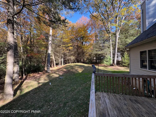a view of backyard with hardwood and deck