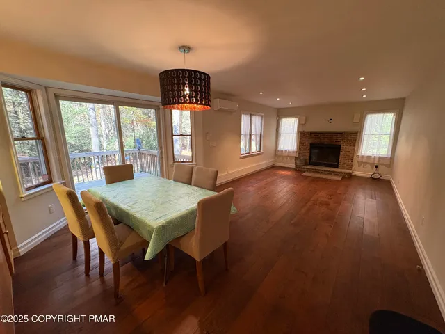 a view of a dining room with furniture window and wooden floor