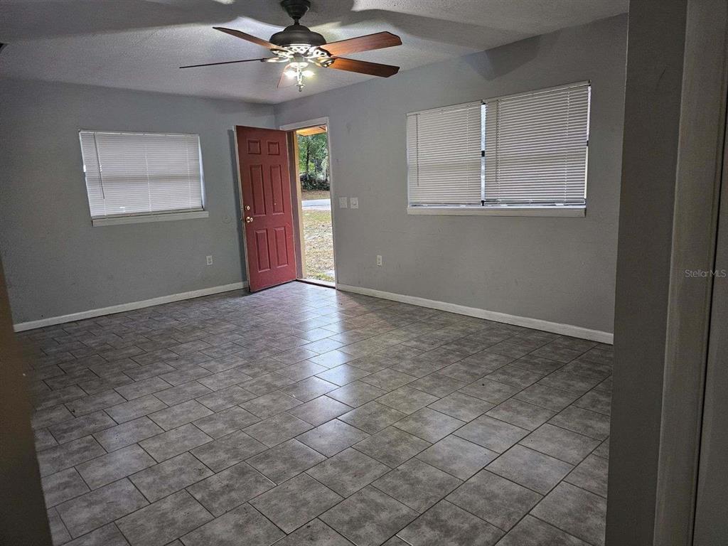112 Jasper Street Bushnell, FL 33513 - Photo 5 of 12 an empty room with windows and fan