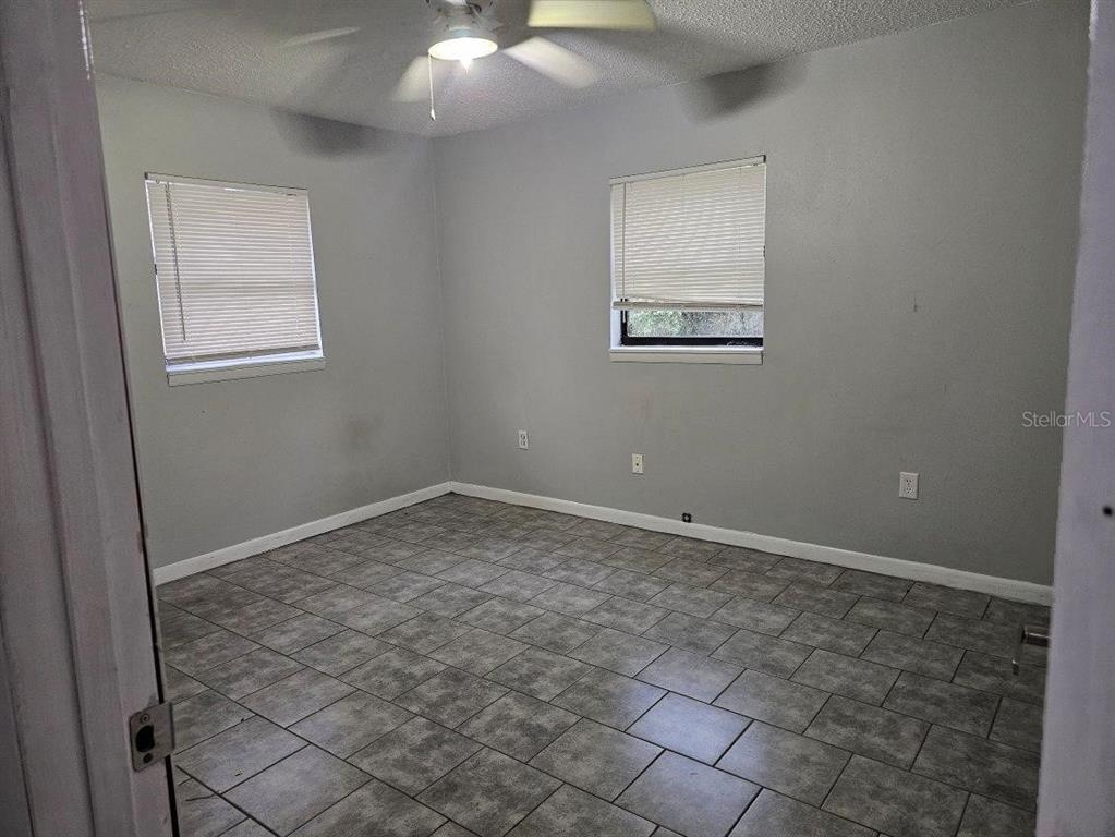 112 Jasper Street Bushnell, FL 33513 - Photo 6 of 12 an empty room with a bench