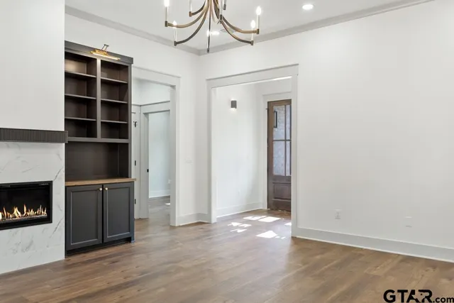 a view of an empty room with a fireplace and a window