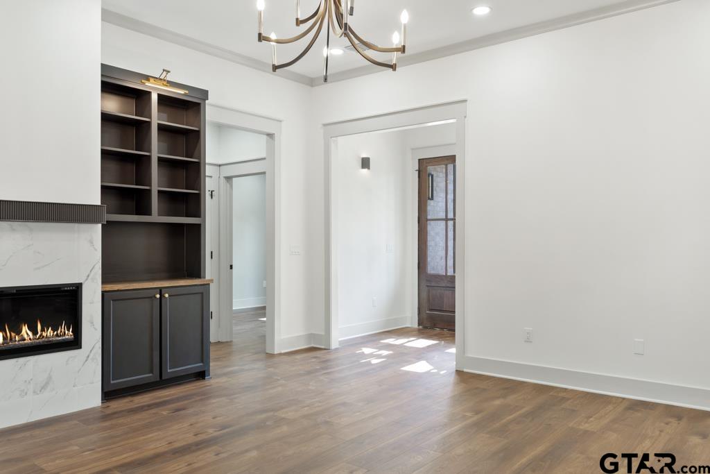 15837 Stillwaters Lindale, TX 75771 - Photo 11 of 34 a view of an empty room with a fireplace and a window