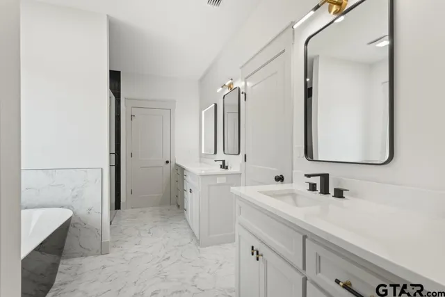 a bathroom with a double vanity sink mirror and double