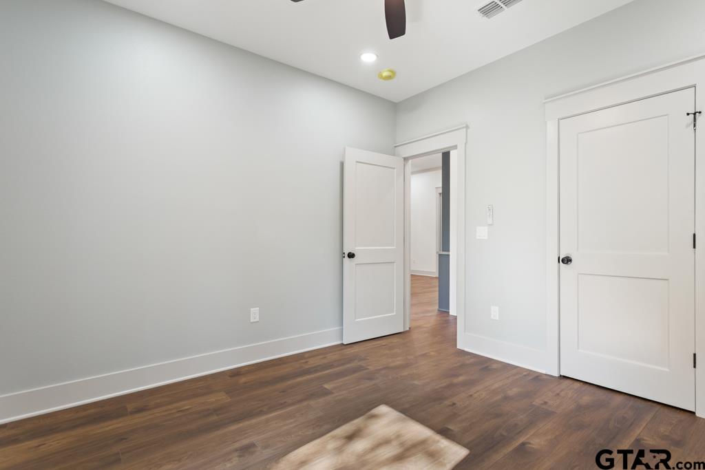 15837 Stillwaters Lindale, TX 75771 - Photo 20 of 34 an empty room with wooden floor and windows