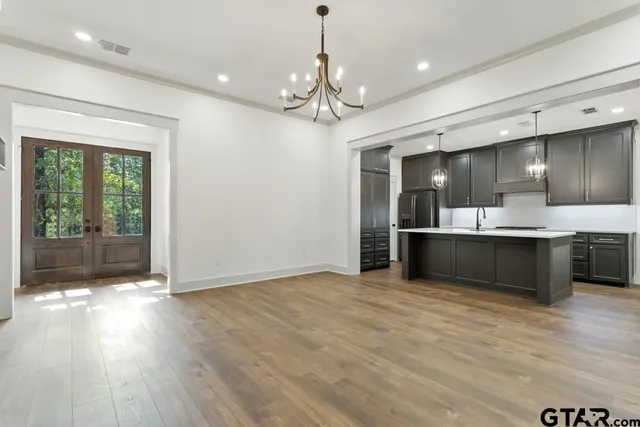 a view of kitchen with refrigerator and window