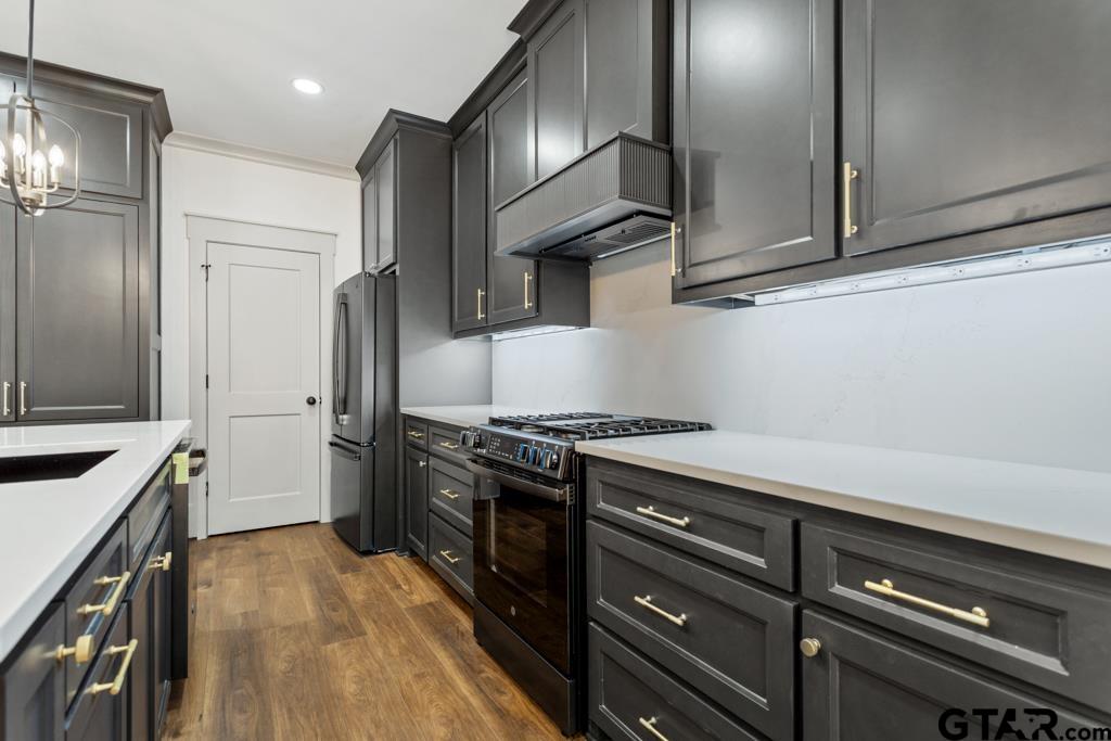 15837 Stillwaters Lindale, TX 75771 - Photo 6 of 34 a kitchen with stainless steel appliances granite countertop a stove and a refrigerator