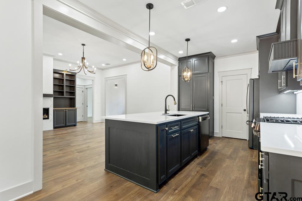 15837 Stillwaters Lindale, TX 75771 - Photo 7 of 34 a large kitchen with stainless steel appliances granite countertop a stove and a refrigerator
