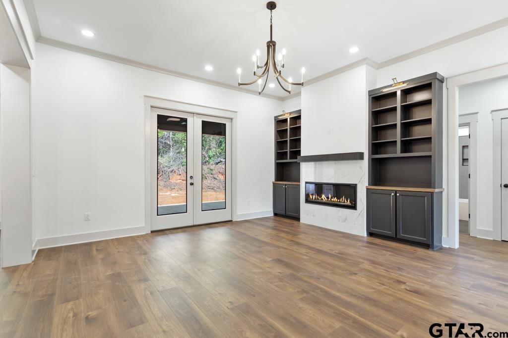 15837 Stillwaters Lindale, TX 75771 - Photo 10 of 34 a view of an empty room with a fireplace and a window