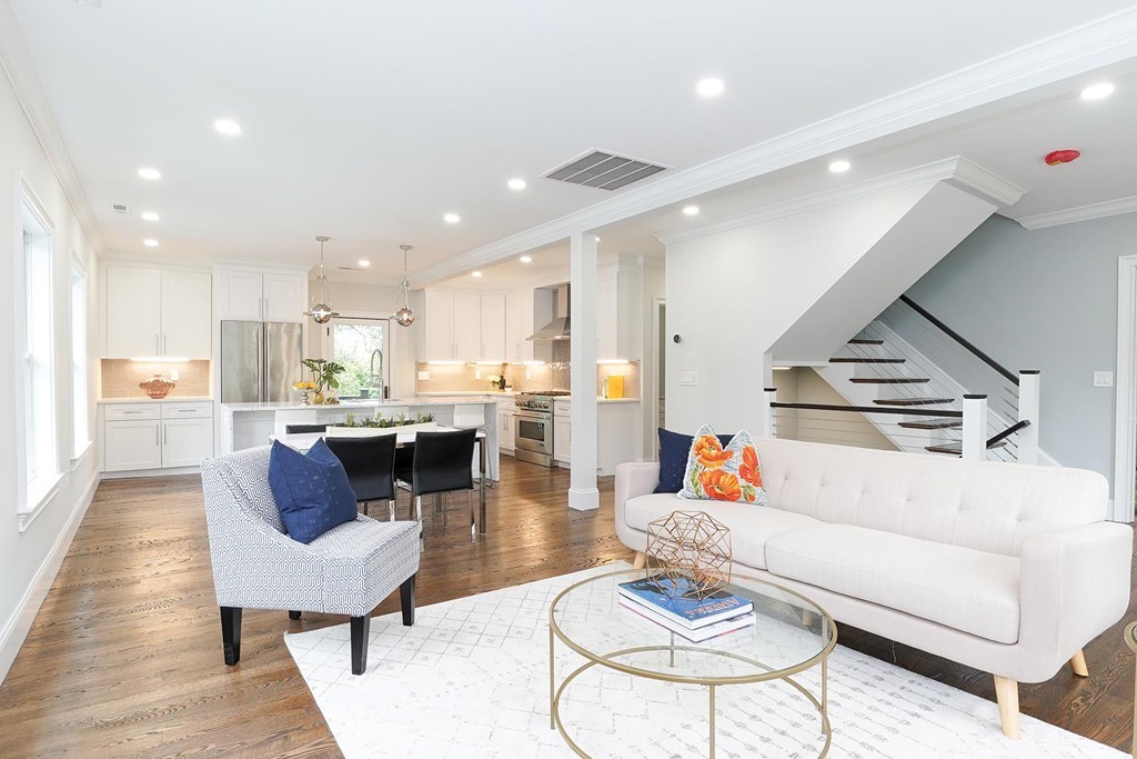 a living room with furniture and kitchen view
