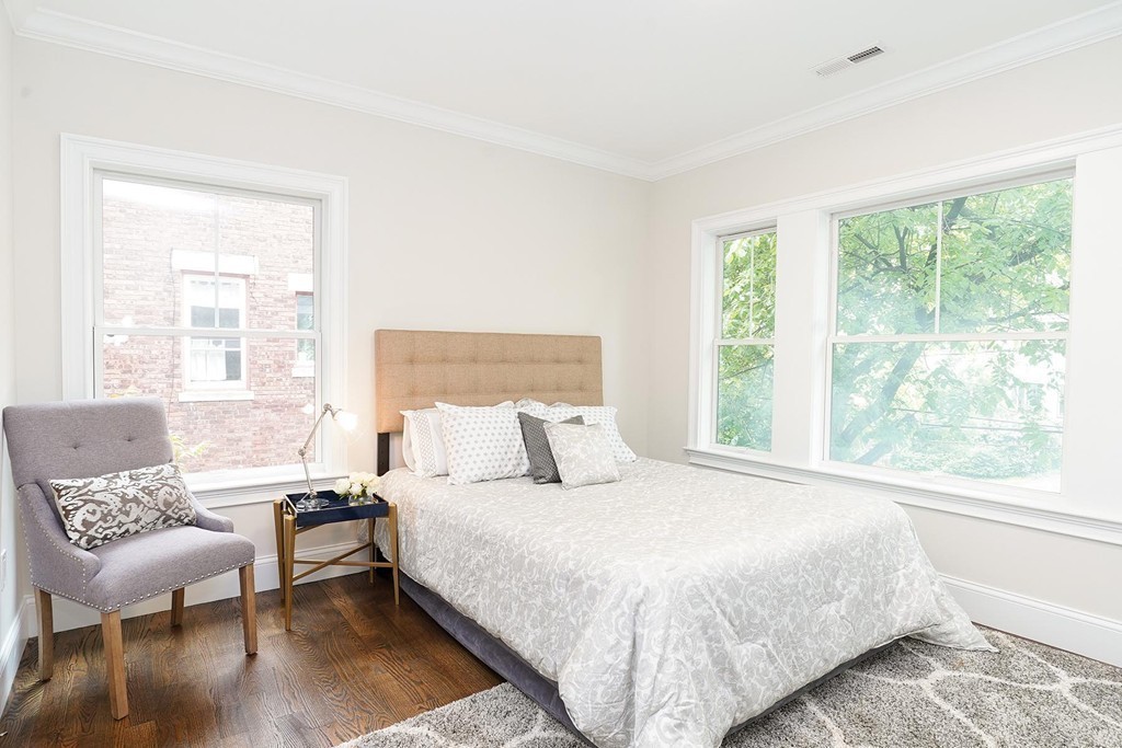 19 Verndale Street, Unit 2 Brookline, MA 02446 - Photo 5 of 8 a bedroom with a bed and wooden floor