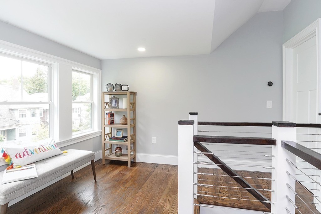 19 Verndale Street, Unit 2 Brookline, MA 02446 - Photo 8 of 8 a view of an empty room with window wooden floor and cabinet