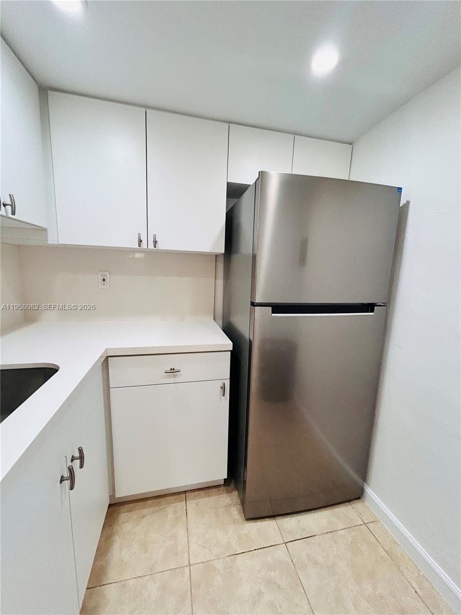 8603 Southwest 68th Court, Unit 22 Miami, FL 33156 - Photo 12 of 49 a utility room with cabinets washer and dryer