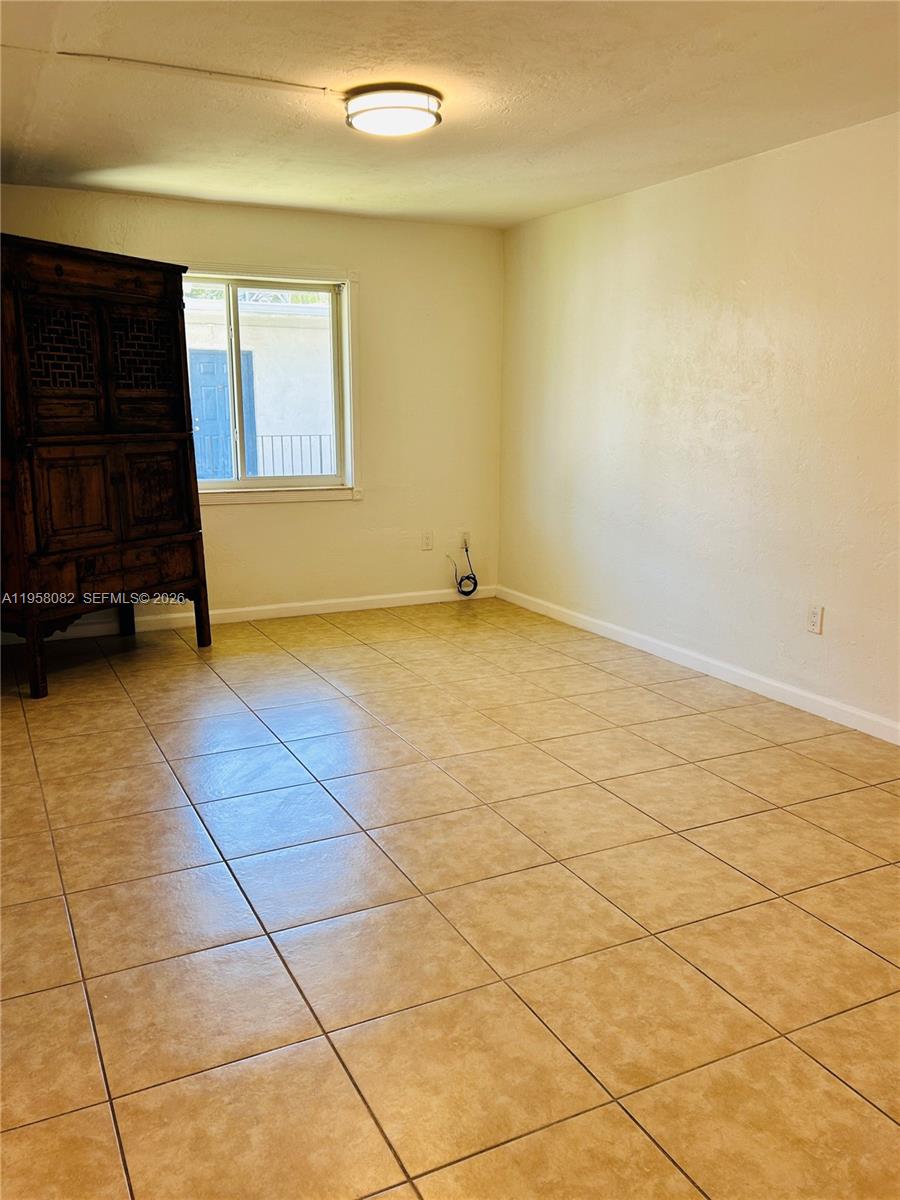8603 Southwest 68th Court, Unit 22 Miami, FL 33156 - Photo 14 of 49 a view of an empty room and a window