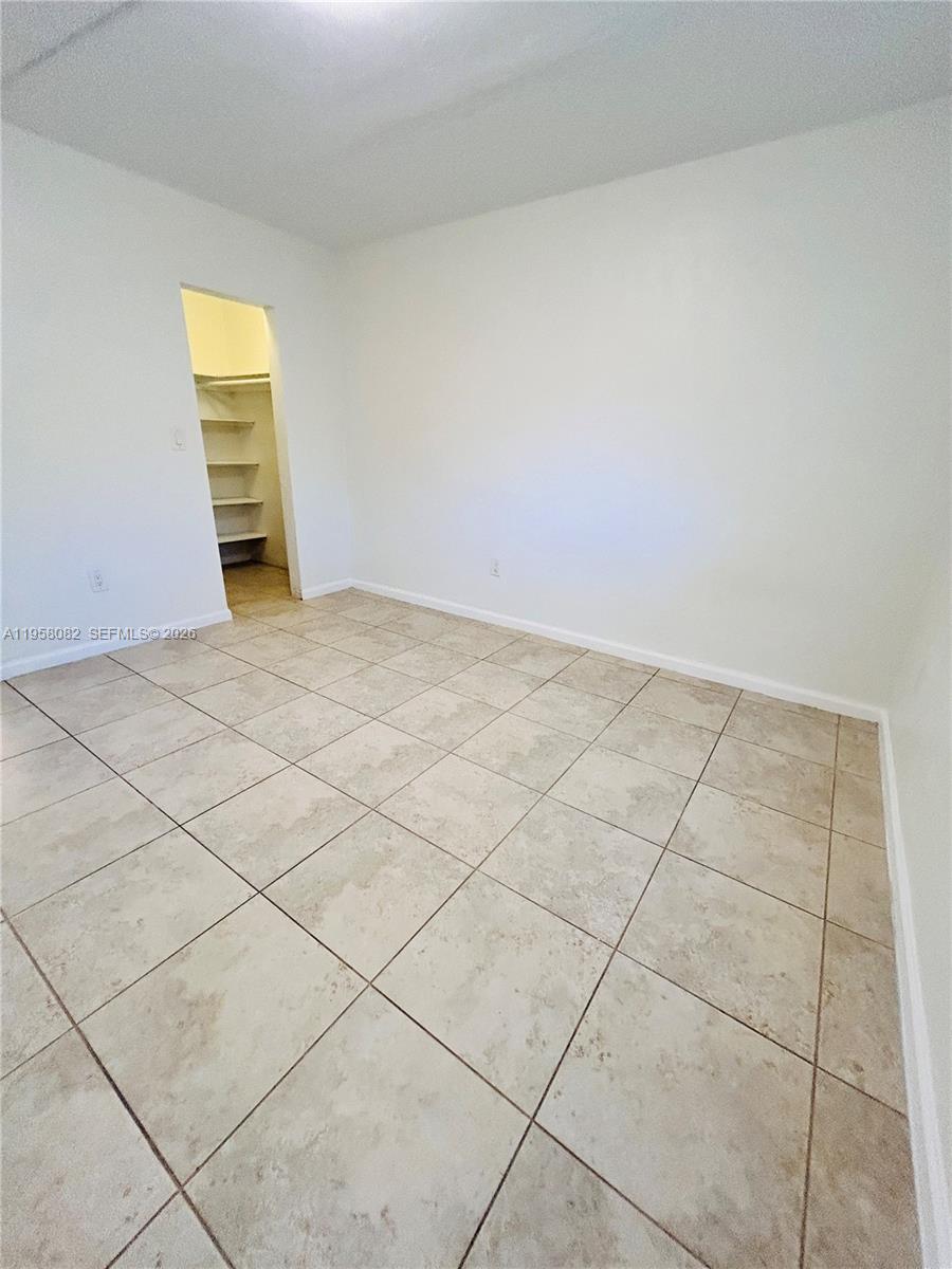 8603 Southwest 68th Court, Unit 22 Miami, FL 33156 - Photo 17 of 49 a view of an empty room and a window