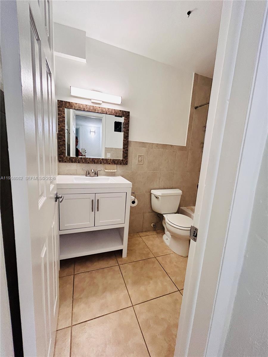 8603 Southwest 68th Court, Unit 22 Miami, FL 33156 - Photo 20 of 49 a bathroom with a toilet sink and mirror