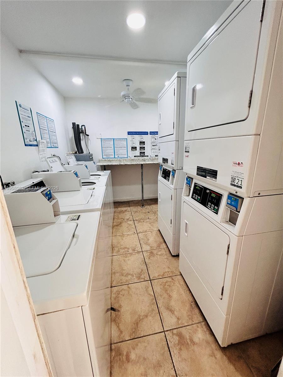 8603 Southwest 68th Court, Unit 22 Miami, FL 33156 - Photo 36 of 49 a kitchen with cabinets and white appliances