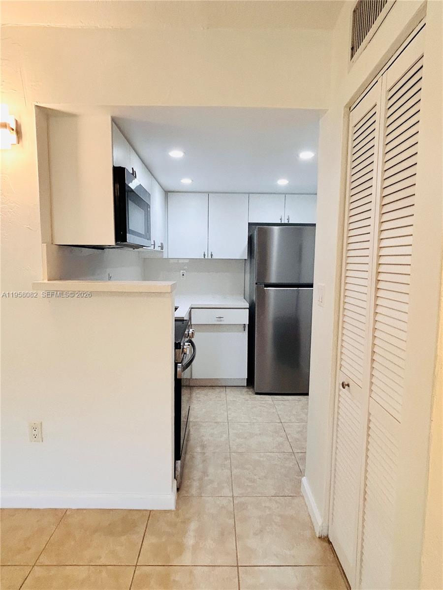 8603 Southwest 68th Court, Unit 22 Miami, FL 33156 - Photo 4 of 49 a kitchen with a refrigerator and a sink