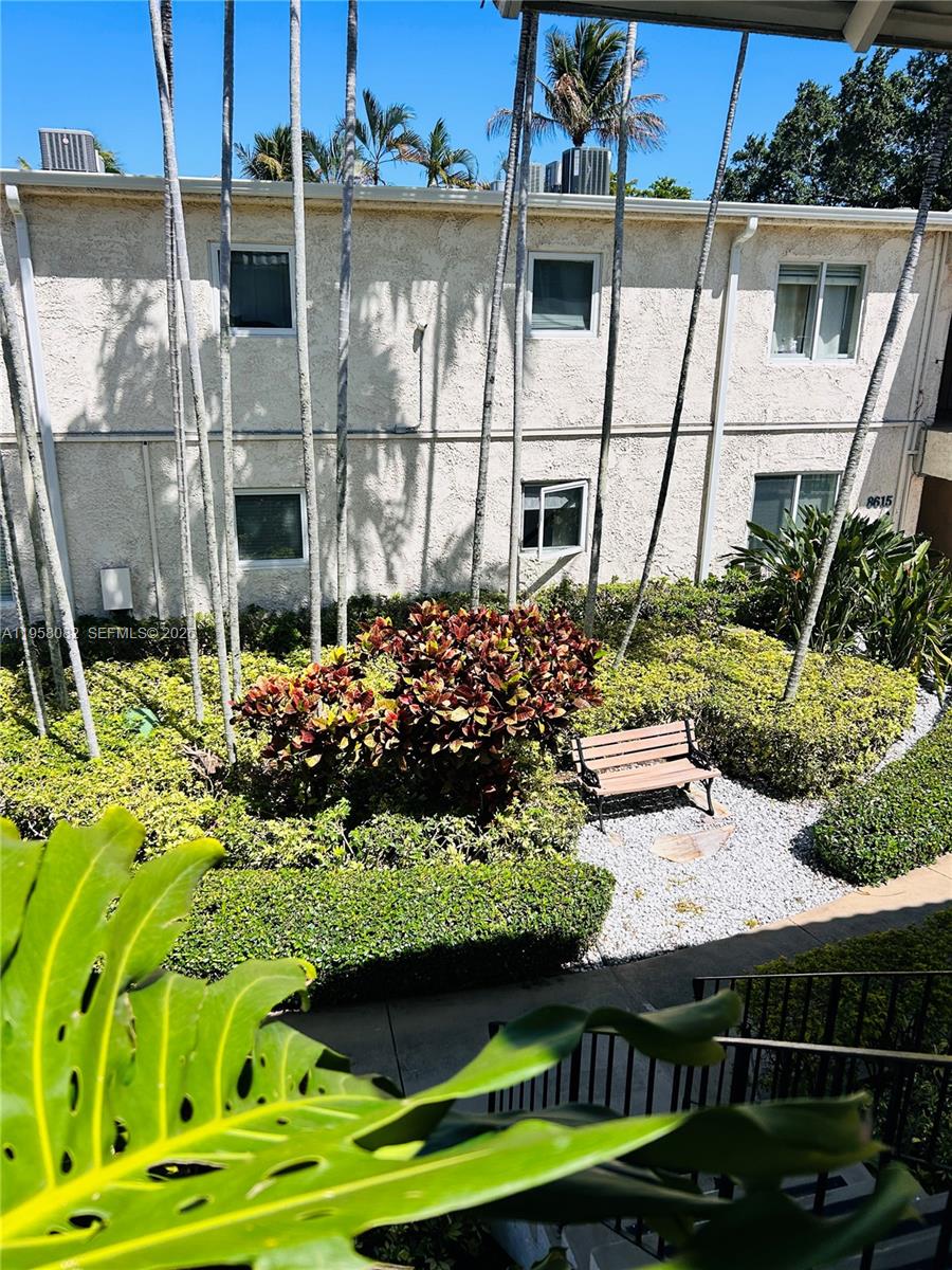 8603 Southwest 68th Court, Unit 22 Miami, FL 33156 - Photo 41 of 49 a view of a white house with a yard and potted plants