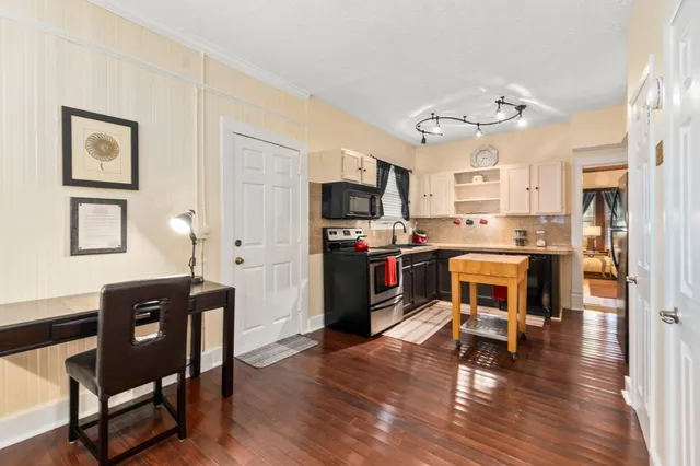 a bathroom with a sink a toilet and shower curtain