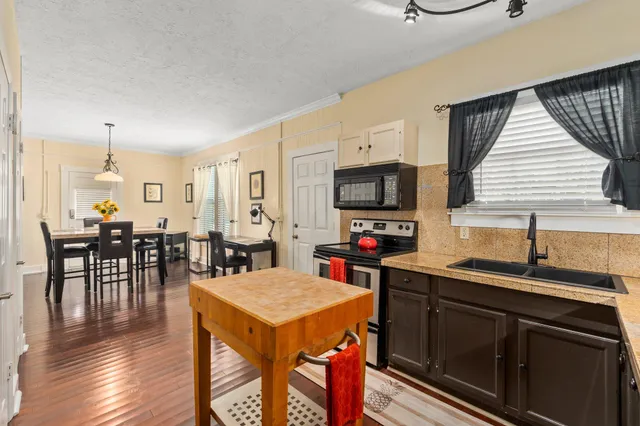 a living room with furniture and a air conditioner vent