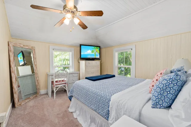 a view of a patio with table and chairs potted plants and large trees