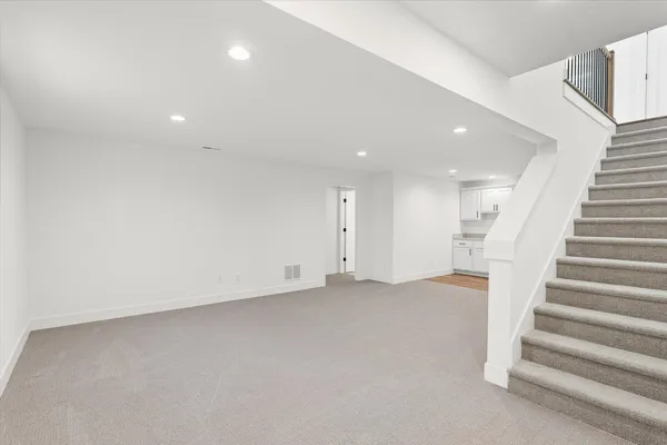 a view of an empty room with stairs