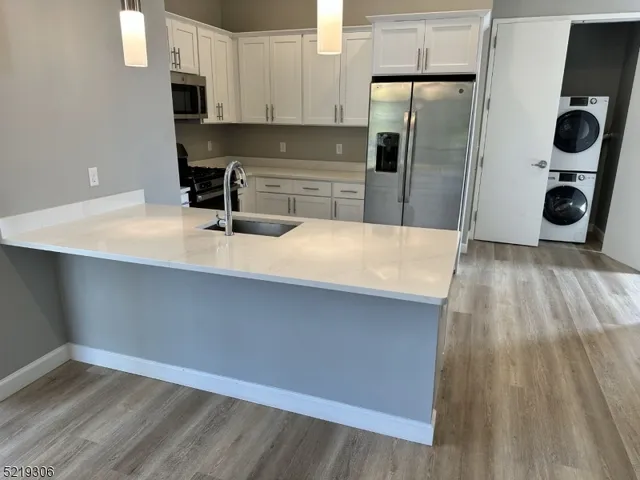 a kitchen with kitchen island a counter top space and stainless steel appliances