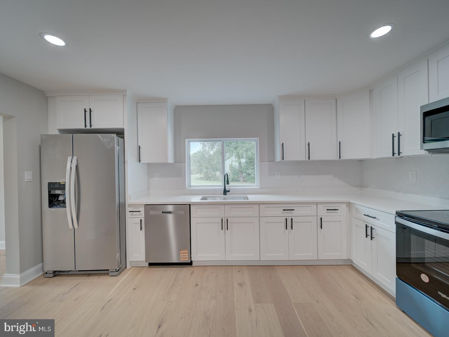 842 South Stepney Road Aberdeen, MD 21001 - Photo 39 of 50 a kitchen with granite countertop white cabinets and refrigerator