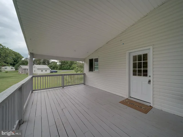 a view of a deck with wooden floor and fence