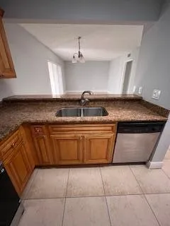 a view of kitchen with granite countertop window