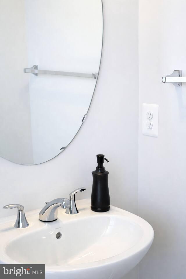 5611 Alpha Ridge Avenue Hyattsville, MD 20782 - Photo 11 of 18 a bathroom with a sink and a mirror
