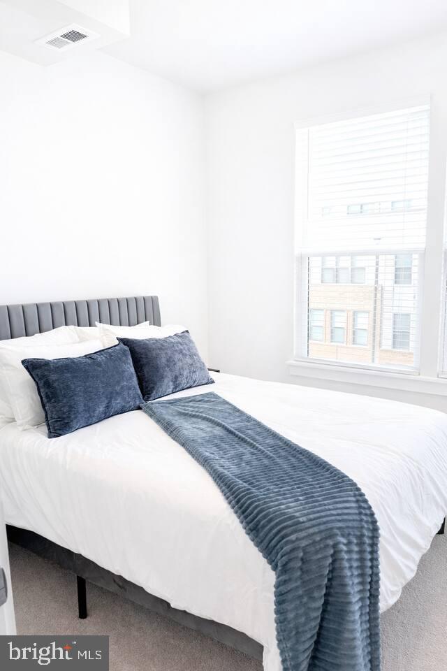 5611 Alpha Ridge Avenue Hyattsville, MD 20782 - Photo 14 of 18 a bedroom with a large bed and a large window
