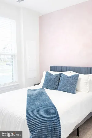 a bedroom with a large bed and a large window