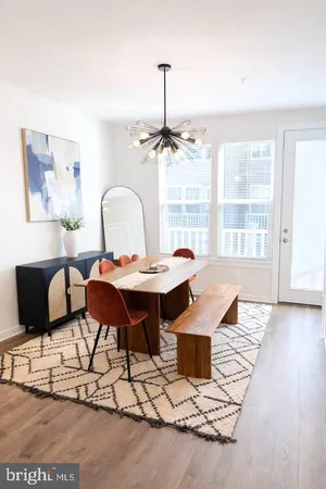a living room with furniture a table and a large window